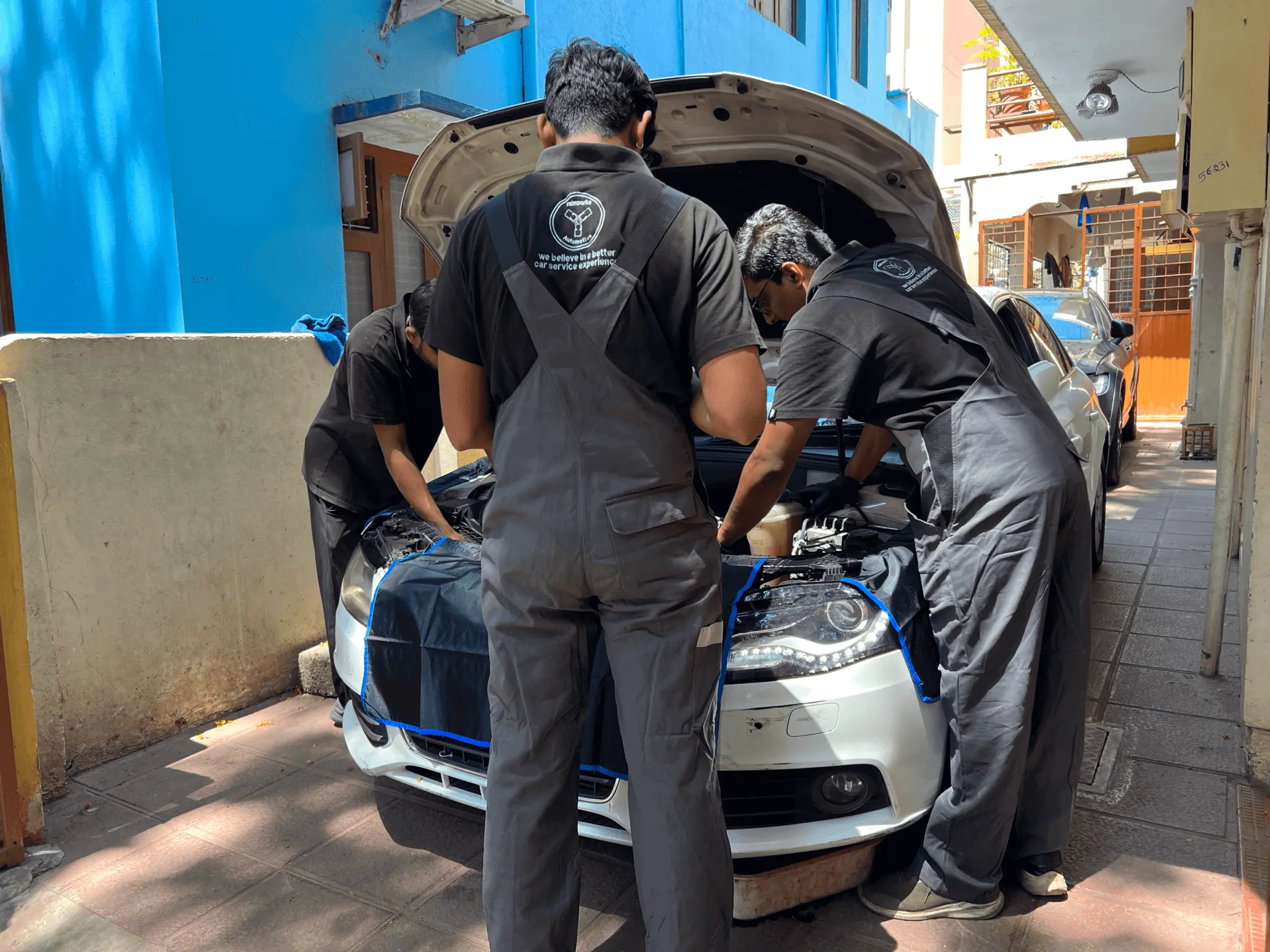 mechanices repairing a car